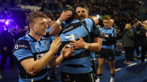 Cardiff players embrace and clap after defeating Stormers