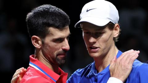 Novak Djokovic and Jannik Sinner congratulate each other after their match at the Davis Cup