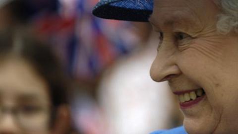 Queen Elizabeth II with a crowd in the background