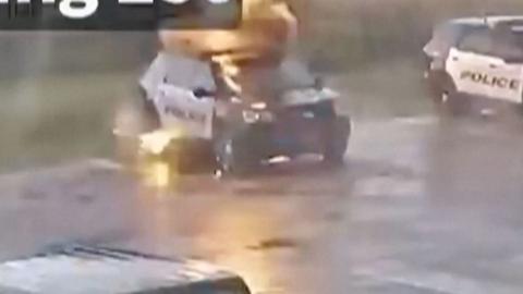 A police car hit by lightning.