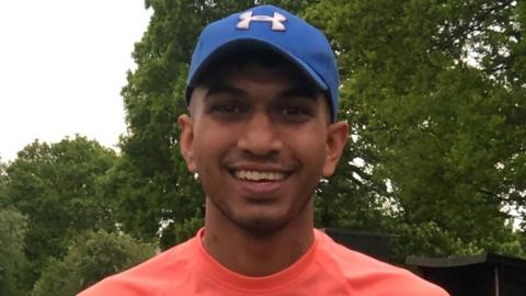 A young man in a baseball cap