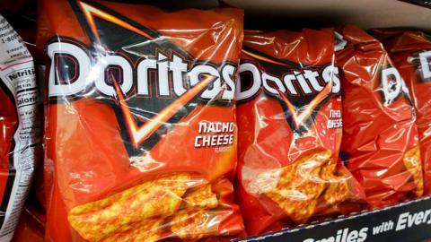 A bag of Doritos Nacho Cheese flavour. the packaging is bright red