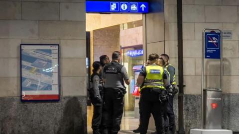 Geneva police officers and railway security guards are seen at Geneva Cornavin train station, on 24 September 2024