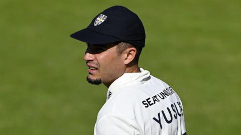 Codi Yusuf, wearing a Durham cap, in the field during a Championship match