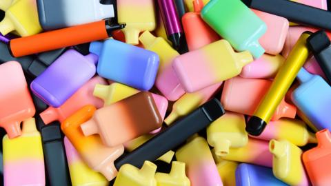 A pile of small, colourful plastic devices. 