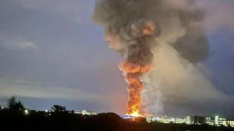 Smoke and flames rise from the factory fire