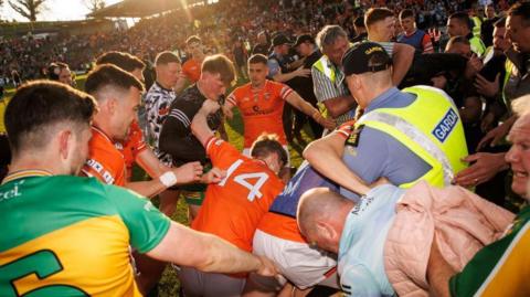 Gardai intervene after a melee on the pitch after the Ulster final between Donegal and Armagh