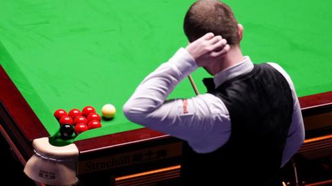 Mark Allen scratches his head