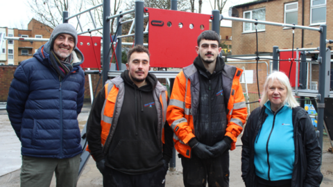 Capital programme and regeneration projects officer Jeremy Trill from Charnwood Borough Council, contractors Brandon Taylor and Rico Angieri from Rico Scapes Ltd and councillor Anne Gray posing for a photo in a line on a play area.