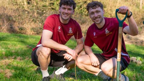 Bradford defenders Joe Wright and Matt Pennington planting a tree