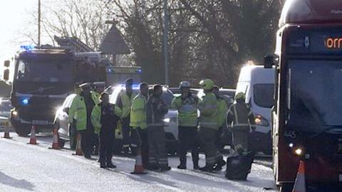 A picture of the bus and emergency services personnel, including a fire engine, on the slip road.