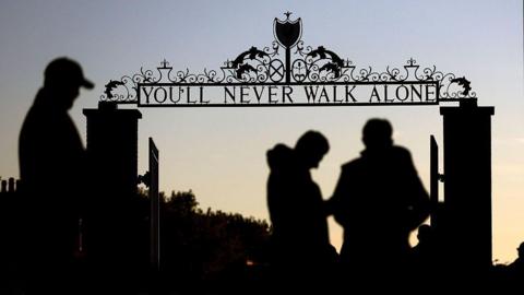 A silhouetted view of the Shankly Gates outside Anfield which read 'You'll Never Walk Alone'