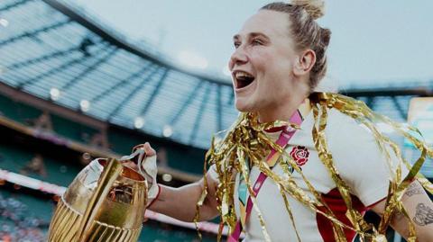 Meg Jones celebrate with the Rugby World Cup trophy