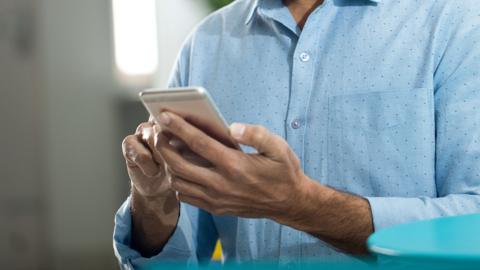 A man holds a phone in his hands