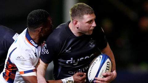 Bath's Finn Russell (right) is tackled by Edinburgh's Malelili Satala-Navlivou