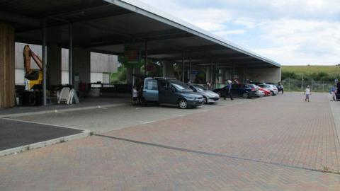 Several cars pictured in bays at Bridport's household recycling centre.