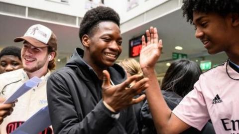 Two teenage boys high fiving