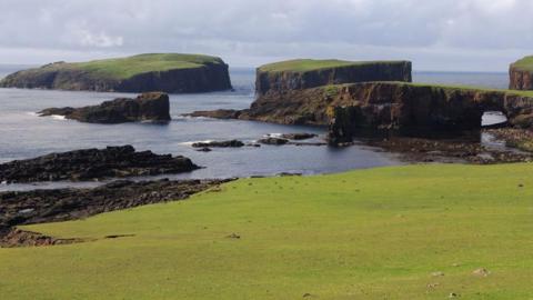 A series of small islands and coastal arches on Papa Stour