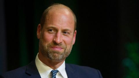 Prince William is photographed at the Earthshot Prize awards in Rio de Janeiro on 5 November. He is wearing a dark suit, white shirt and navy and blue spotty tie.
