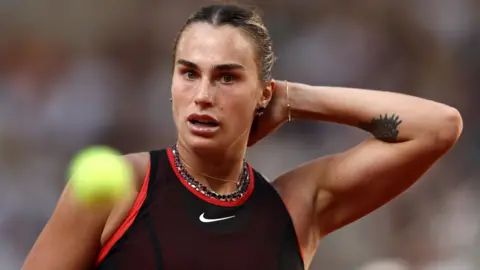 Aryna Sabalenka looks on