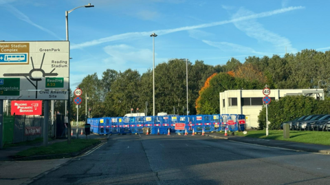 A general view picture of Bennet Road, a main road in Reading, with blue crash barriers around it.