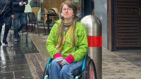 Rae in wheelchair outside subway