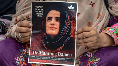 A supporter holds a poster of Dr Mahrang Baloch, nominated for the 2025 Nobel Peace Prize, during a protest in Islamabad, on July 16, 2025, against her imprisonment. 