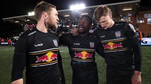 Brett Connon (left) Christian Wade (centre) and Alex Hearle (right) arm-in-arm with each other after Newcastle Red Bulls' win over Gloucester