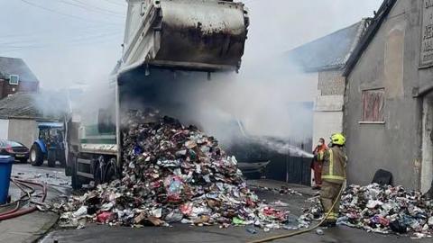 A bin lorry fire being extinguished in Worksop