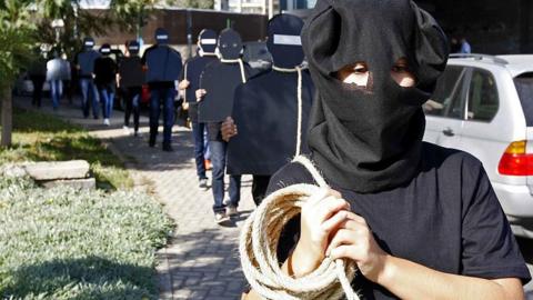 Protesters hold cardboard figures with ropes round their necks during a rally against the death penalty in Beirut, Lebanon. File photo from October 2013.