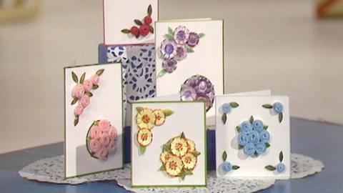 Five cards with different coloured floral brooches