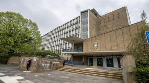 Durham County Council's offices at Aykley Heads. The building is seven storeys tall and made of brown stone.