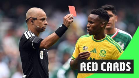 Referee Wilton Pereira Sampaio shows a red card to South Africa's Themba Zwane