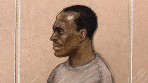 A court sketch of Hadush Kebatu, who is wearing a grey sweater and has short black hair.