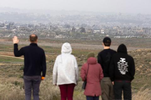 People look at Gazan ruins from a view point near the border in Israel, amid a ceasefire between Israel and Hamas, Israel February 5, 2025