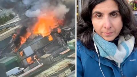 Flames and smoke emerged from a building on the left. BBC Reporter on the right.