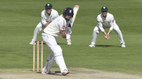 Will Rhodes looks to drive during his century for Warwickshire at Worcester