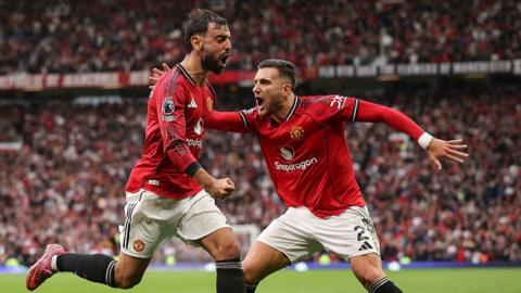 Manchester United defender Diogo Dalot celebrates with Bruno Fernandes
