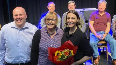 Suranne Jones being presented with a bouquet of flowers from staff and supporters of the theatre.