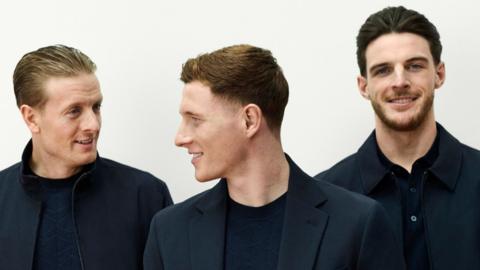 Jordan Pickford, Elliot Anderson, Declan Rice pose in navy smart-casual clothing from the M and S England collection