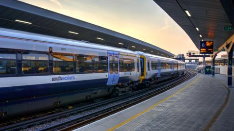 Southeastern train, in its blue and white livery, waiting at platform at London Bridge station London United Kingdom indicating first class accommodation