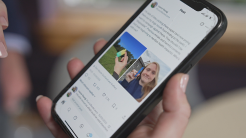 A smart phone held in the hand shows the first tweet by Laura Young about vapes, with pictures of her holding the devices she found