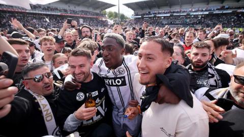 Elversberg players and supporters celebrate on the pitch