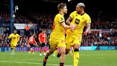 James McAtee of Sheffield United celebrates scoring his team's second goal with teammate James McAtee during the Premier League match between Luton Town and Sheffield United at Kenilworth Road