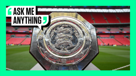 The Community Shield trophy sits on a plinth in front of the pitch at Wembley Stadium