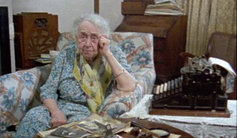 Frances Jones sits next to an old typewriter.