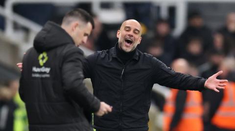 Manchester City's Pep Guardiola argues with the fourth official