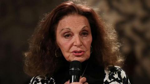 Diane von Furstenberg holding a microphone