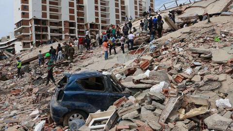 Car stuck in rubble of building and Venezuela