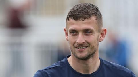 Adam Smith looks on before a Hartlepool United game in August 2025
